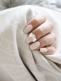 Close-up of woman hand with bow on nail