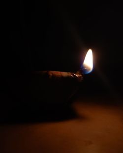 Close-up of illuminated lamp against black background