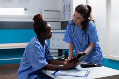 Side view of doctor using mobile phone