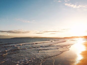 Scenic view of beach against sky during sunset