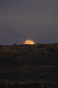 Scenic view of land against sky during sunset