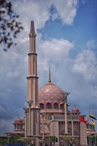 Low angle view of building against cloudy sky