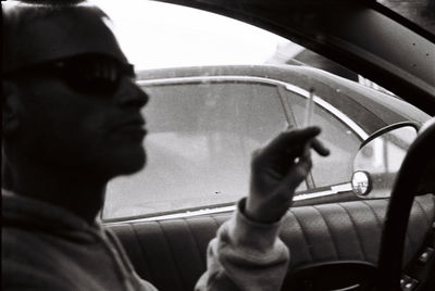 Reflection of man in car mirror