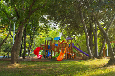 View of playground against trees in park