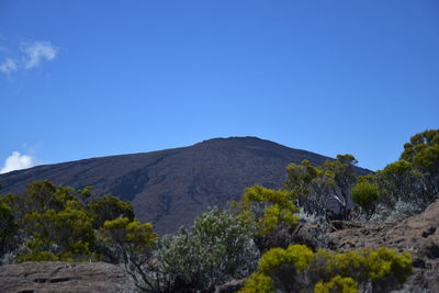 Scenic view of mountains against clear blue sky