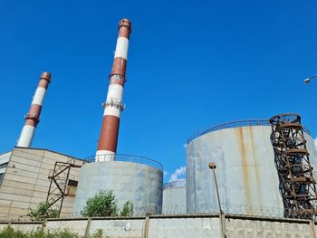 Low angle view of smoke stack against sky