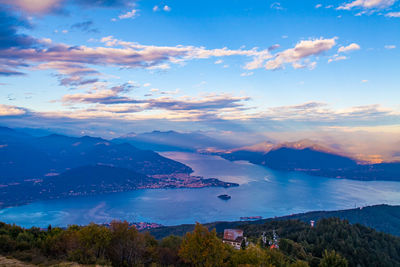 Scenic view of sea and mountains against sky