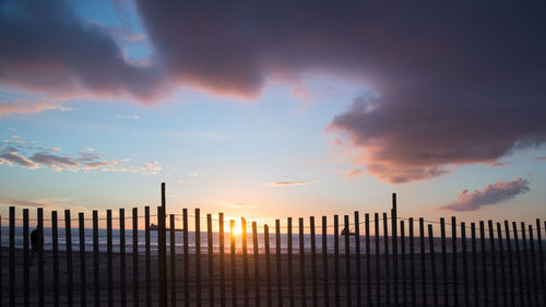 Silhouette buildings against sky during sunset