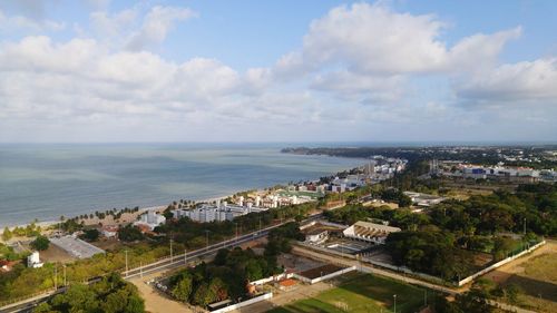 High angle view of cityscape by sea against sky