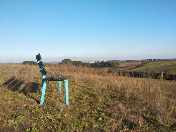 Man standing on field against clear sky