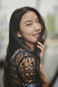 Portrait of smiling young woman standing outdoors