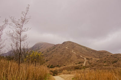 Scenic view of mountains against cloudy sky