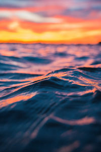 Close-up of sea against sky during sunset