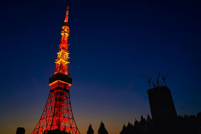 Low angle view of illuminated building against sky at night