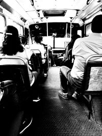 Rear view of people sitting in train