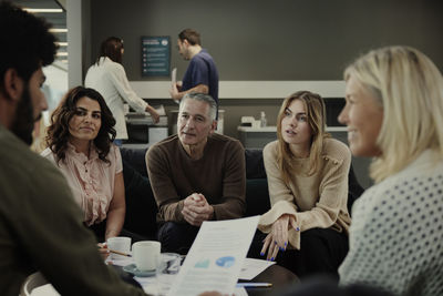 Group of business people having meeting in lobby