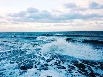 Scenic view of sea against cloudy sky