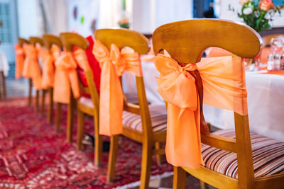 Close-up of orange chairs and table in restaurant