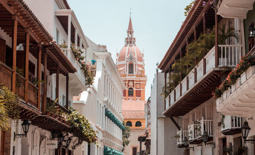 Low angle view of buildings in town against sky