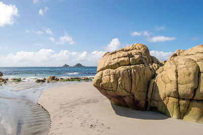 Rocks on beach against sky