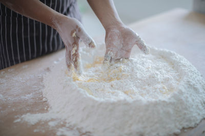 Midsection of person preparing food