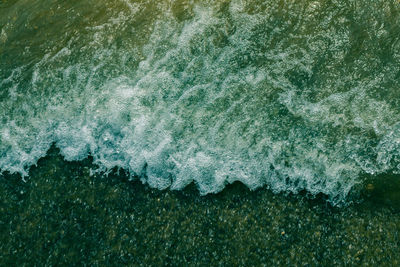 High angle view of waves on sea shore