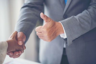 Close-up of business people shaking hands