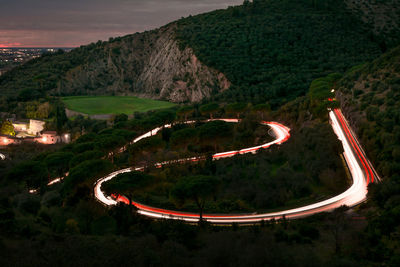 High angle view of light trails on road against sky at night