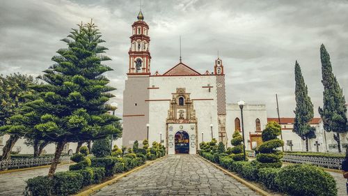 View of bell tower against cloudy sky