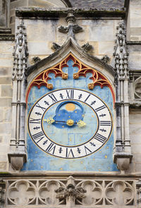 Low angle view of clock tower against building