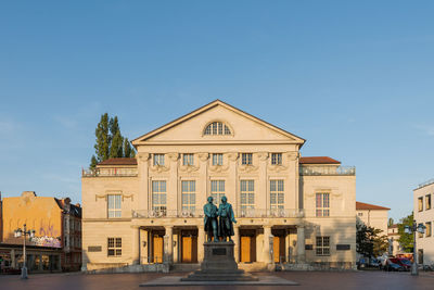 Statue of historic building against blue sky