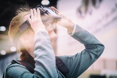 Mid adult woman using virtual reality at home