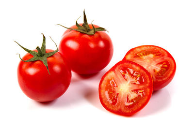 Close-up of tomatoes against white background