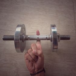 Close-up of hand holding metal