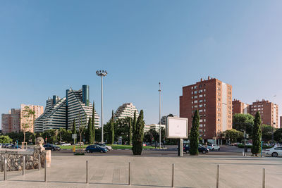 City street and modern buildings against clear sky