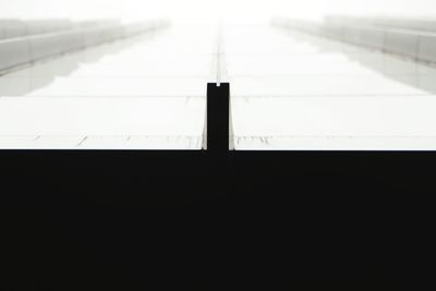 High angle view of shadow on railing against clear sky