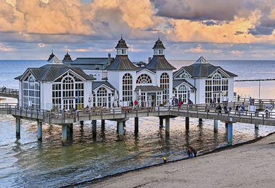 Pier by sea against sky during sunset