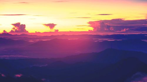 Scenic view of silhouette mountains against sky at sunset