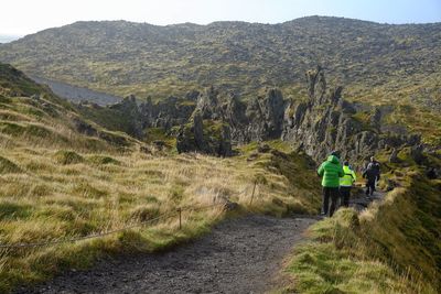 Rear view of man on mountain against sky
