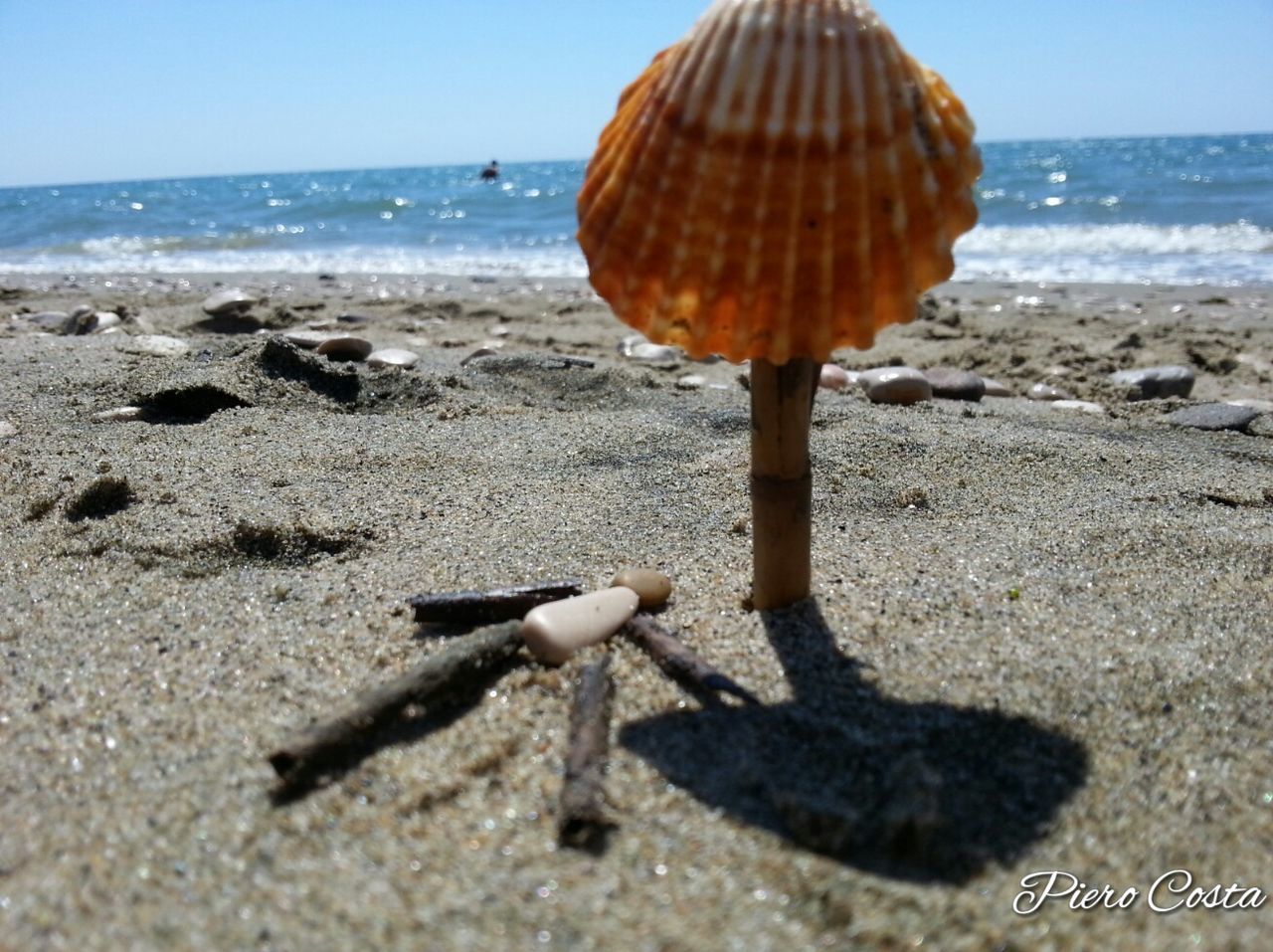 horizon over water, sea, beach, sand, clear sky, water, sunlight, shore, tranquil scene, surface level, outdoors, sunny, scenics, day, nature, tranquility, ocean, beauty in nature, coastline, creativity, wave, weathered