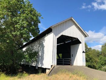 Abandoned building against sky on sunny day