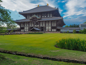 View of temple on field against sky