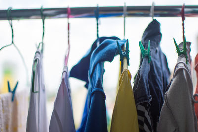 Close-up of clothes hanging on rack at store