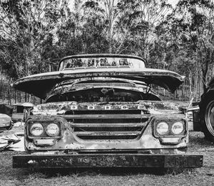 View of abandoned car on field