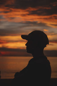 Silhouette man standing against sky during sunset