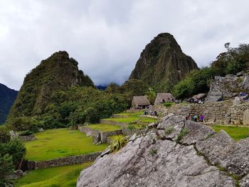 Built structure on mountain against cloudy sky