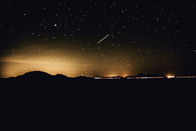 Scenic view of landscape against star field