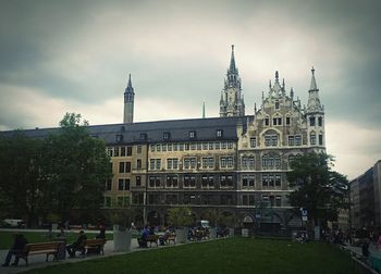 Buildings against cloudy sky