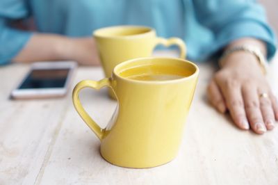 Midsection of coffee cup on table