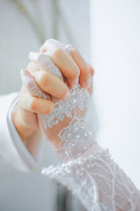 Midsection of woman holding dentures